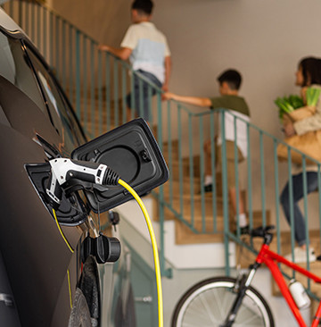 Electric Vehicle charging while family enters their home